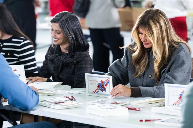 The First Lady and Second Lady joined volunteers to sign holiday cards included in American Red Cross care packages for deployed service members.